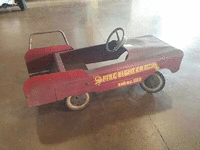 Image 1 of 2 of a N/A FIREFIGHTER PEDAL CAR RED SEAT NO BELL