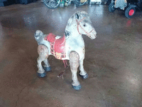 Image 1 of 2 of a N/A ROLLING HORSE SADDLE IS RED AND YELLOW