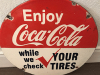 Image 1 of 1 of a N/A ROUND COLA COLA SIGN ENJOY COCA COLA WHILE WE CHECK YOUR TIRES