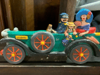 Image 1 of 1 of a N/A CAR FIGURINE W/ 3 PEOPLE