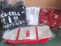 Image 1 of 1 of a N/A LOT OF NEW IN WRAPPER COCA COLA T-SHIRTS, HOODIES AND BAGS